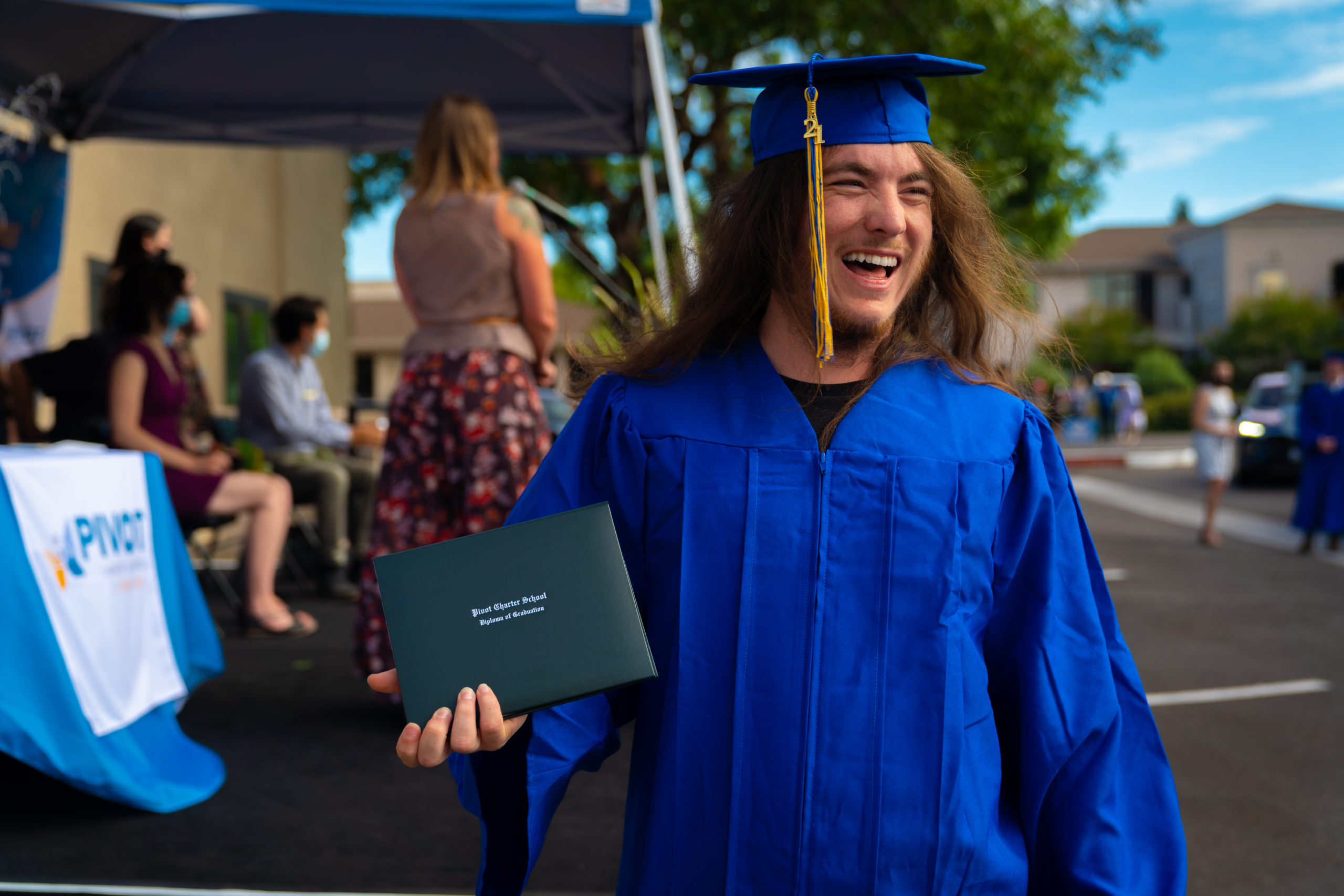 student holding diploma
