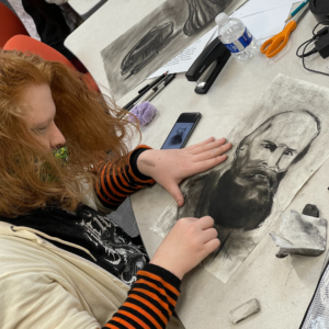 student working with charcoal